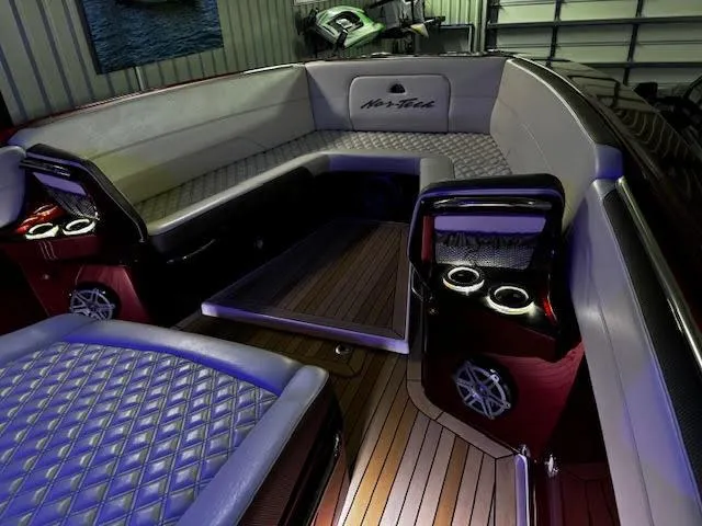 Slide: The Image of 2020 Nor-Tech 390 Sport Center Console interior with luxurious seating and ambient lighting. - 5