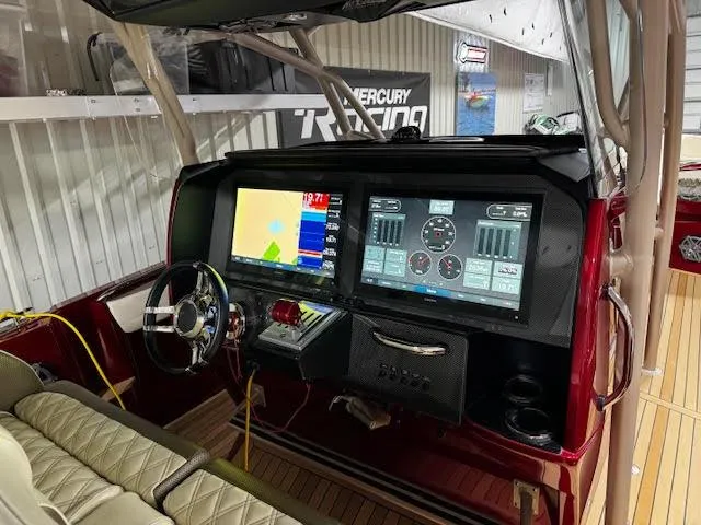 Slide: The Image of 2020 Nor-Tech 390 Sport Center Console dashboard with advanced navigation and control screens. - 6