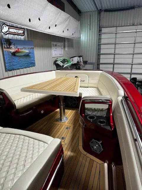 Slide: The Image of 2020 Nor-Tech 390 Sport Center Console interior with white seating and wooden table. - 9