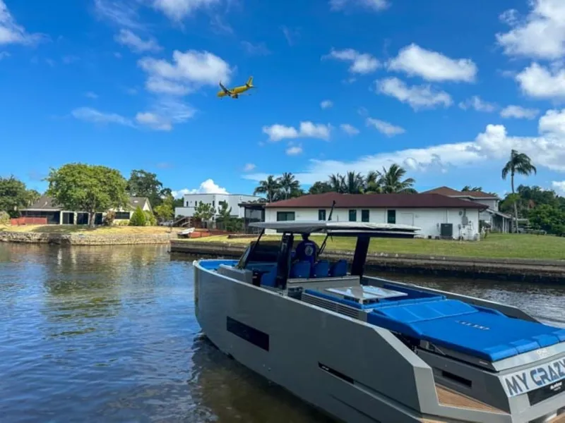 Slide: The Image of De Antonio Yachts D42 Open 2023 docked in a serene waterfront neighborhood. - 6