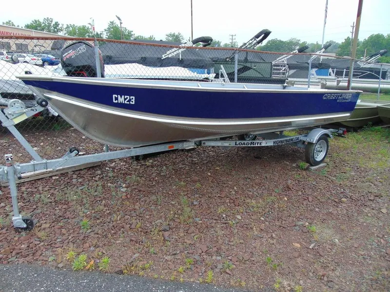 Slide: The Image of 2024 Crestliner 1672 Outreach boat on a trailer in a dealership lot. - 1