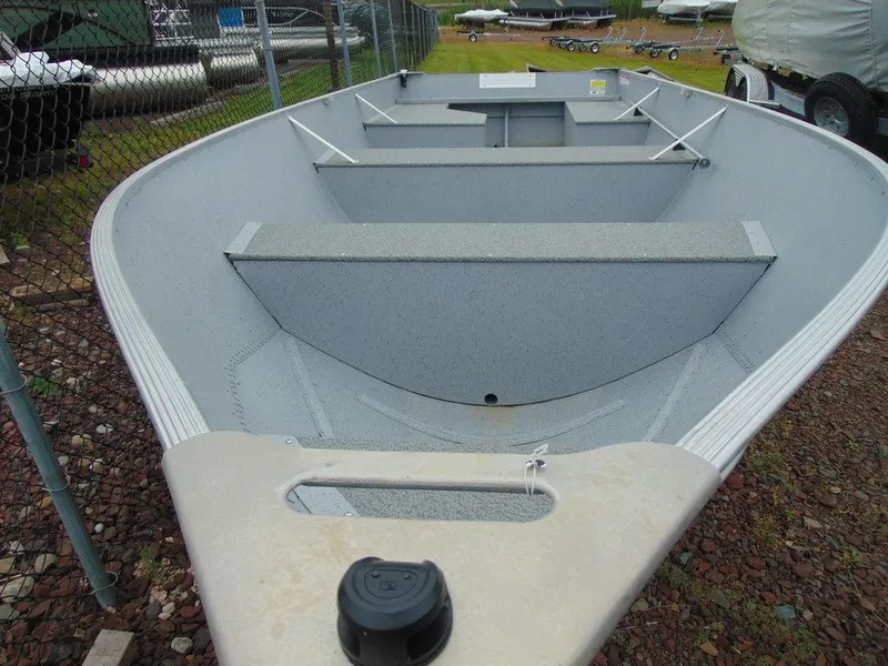 Slide: The Image of 2024 Crestliner 1672 Outreach aluminum boat, interior view, parked on gravel. - 7