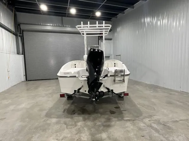 Slide: The Image of 2024 Bayliner T18BAY boat in a storage facility, rear view. - 2
