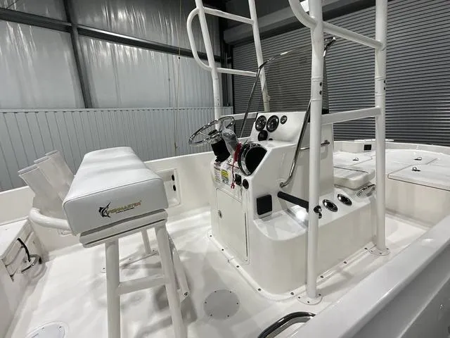 Slide: The Image of 2024 Bayliner T18BAY boat interior with steering console and seating. - 10