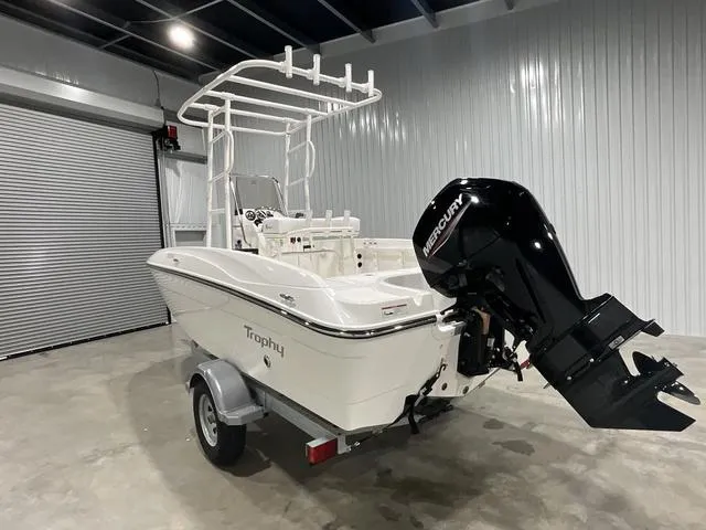 Slide: The Image of 2024 Bayliner T18BAY boat with Mercury outboard motor in a garage. - 8