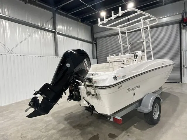 Slide: The Image of 2024 Bayliner T18BAY boat with Mercury outboard motor in a garage. - 4