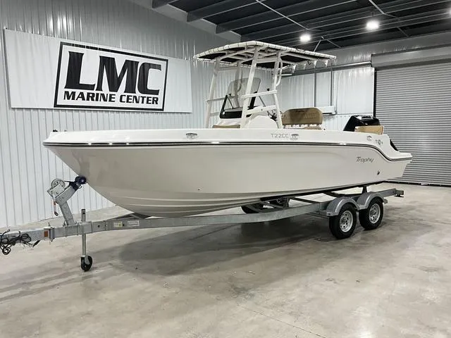 Slide: The Image of 2024 Bayliner T22CC boat cruising on a lake with passengers relaxing. - 1