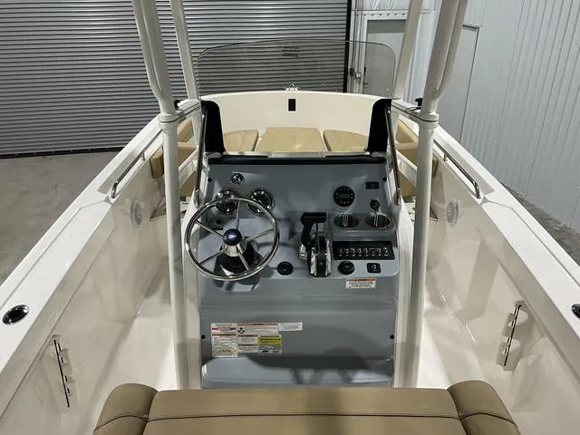 Slide: The Image of 2024 Bayliner T22CC boat interior with steering console and seating. - 12