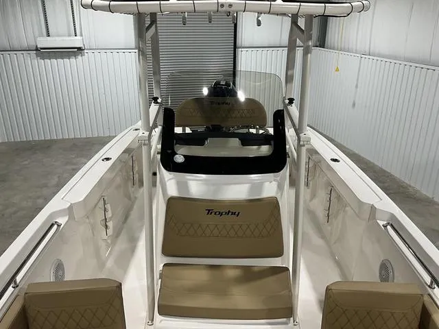 Slide: The Image of 2024 Bayliner T22CC boat interior with beige seating and center console. - 13