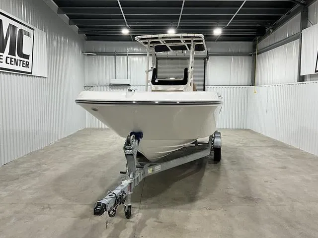 Slide: The Image of 2024 Bayliner T22CC boat on trailer in indoor showroom. - 2