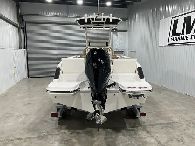 Slide: The Image of 2024 Bayliner T22CC boat in a showroom, rear view with outboard motor. - 3