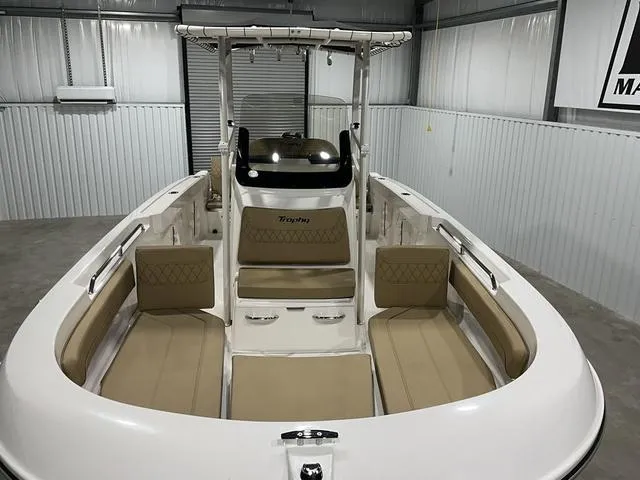 Slide: The Image of 2024 Bayliner T22CC boat interior with beige seating in a storage facility. - 7