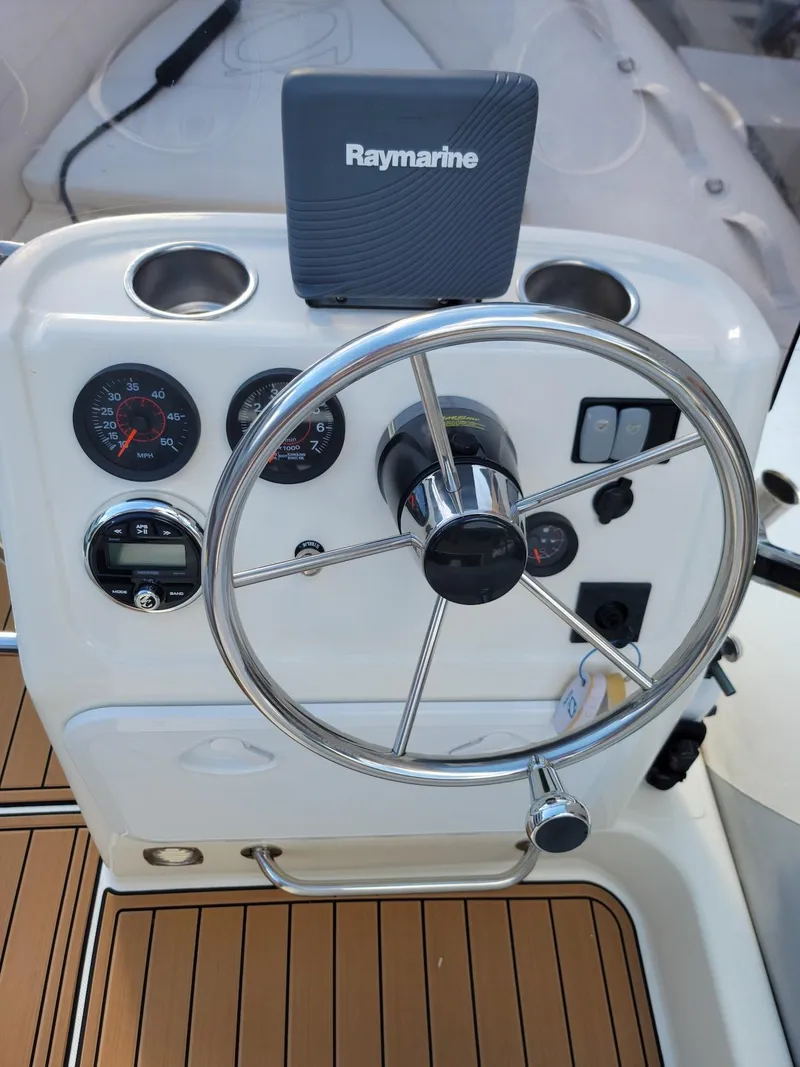 Slide: The Image of 2014 Zodiac Medline 580 boat dashboard with Raymarine navigation system. - 13