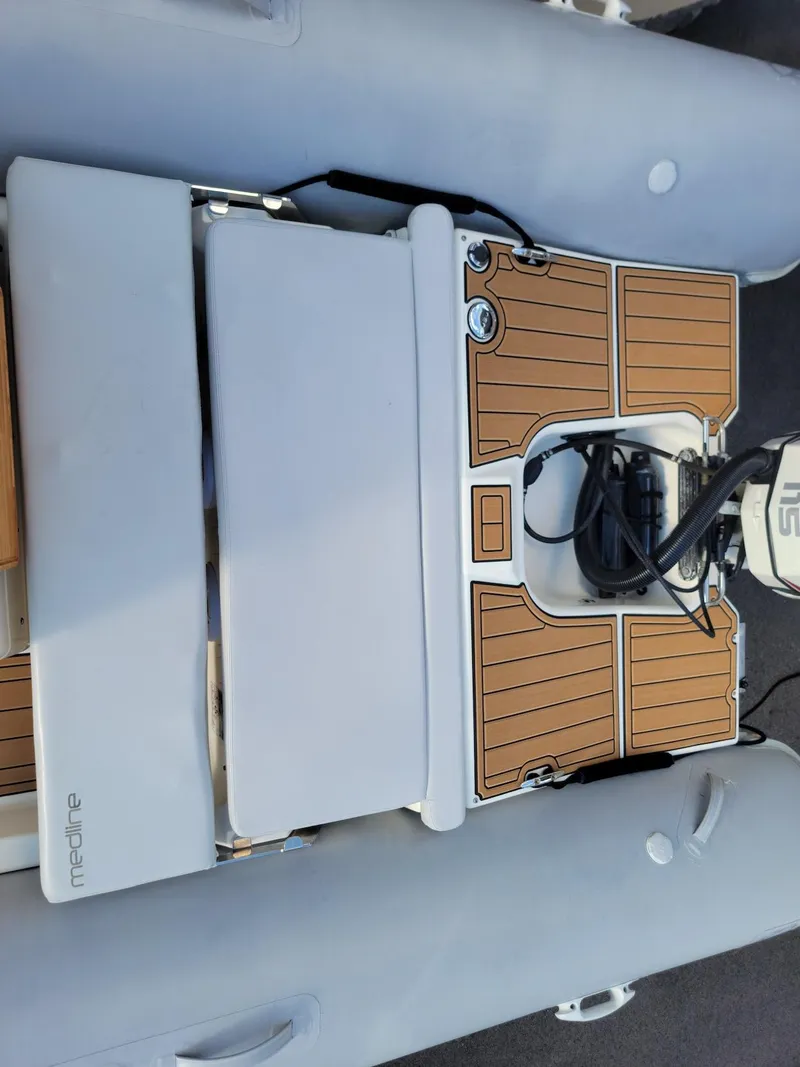 Slide: The Image of 2014 Zodiac Medline 580 inflatable boat with wooden deck and outboard motor. - 17
