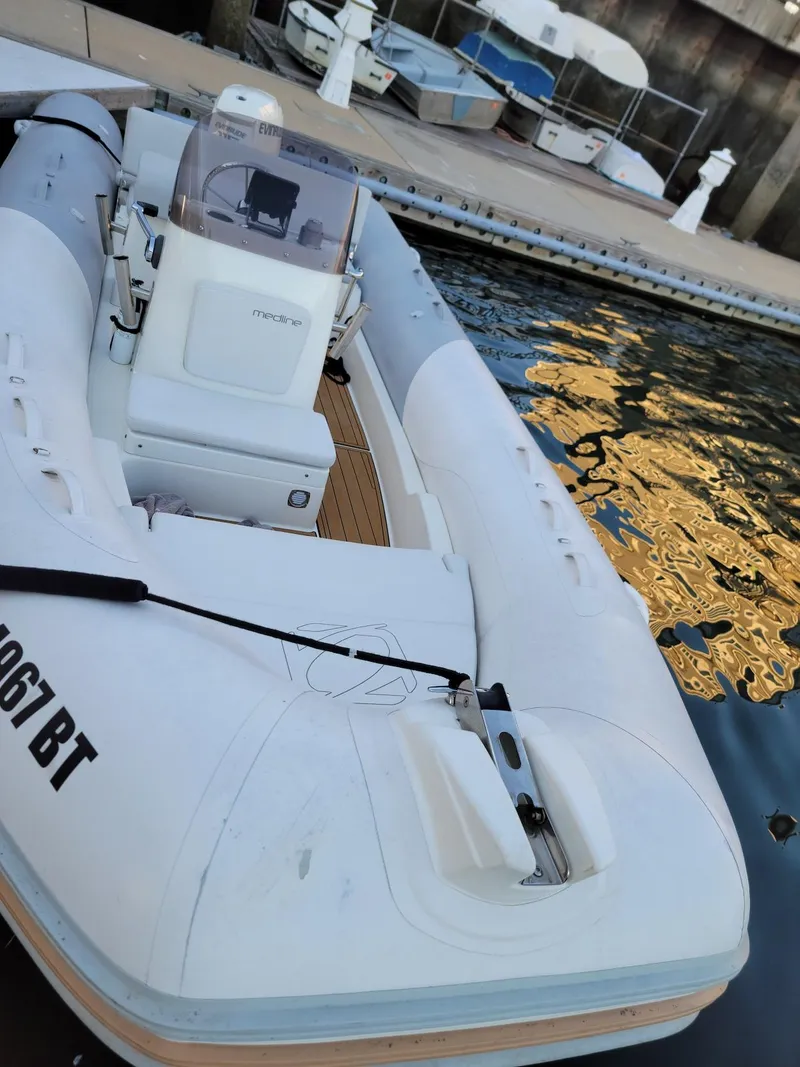 Slide: The Image of 2014 Zodiac Medline 580 inflatable boat docked at a marina. - 19