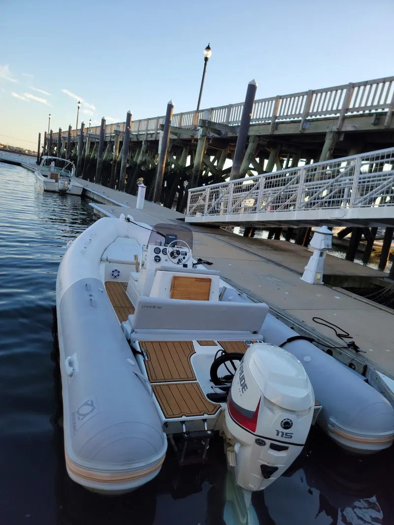 Slide: The Image of 2014 Zodiac Medline 580 inflatable boat docked at a marina. - 2