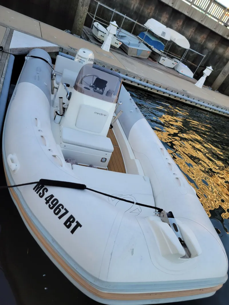 Slide: The Image of 2014 Zodiac Medline 580 inflatable boat docked at a marina. - 21