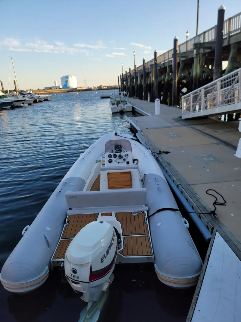 Slide: The Image of 2014 Zodiac Medline 580 inflatable boat docked at a marina. - 23