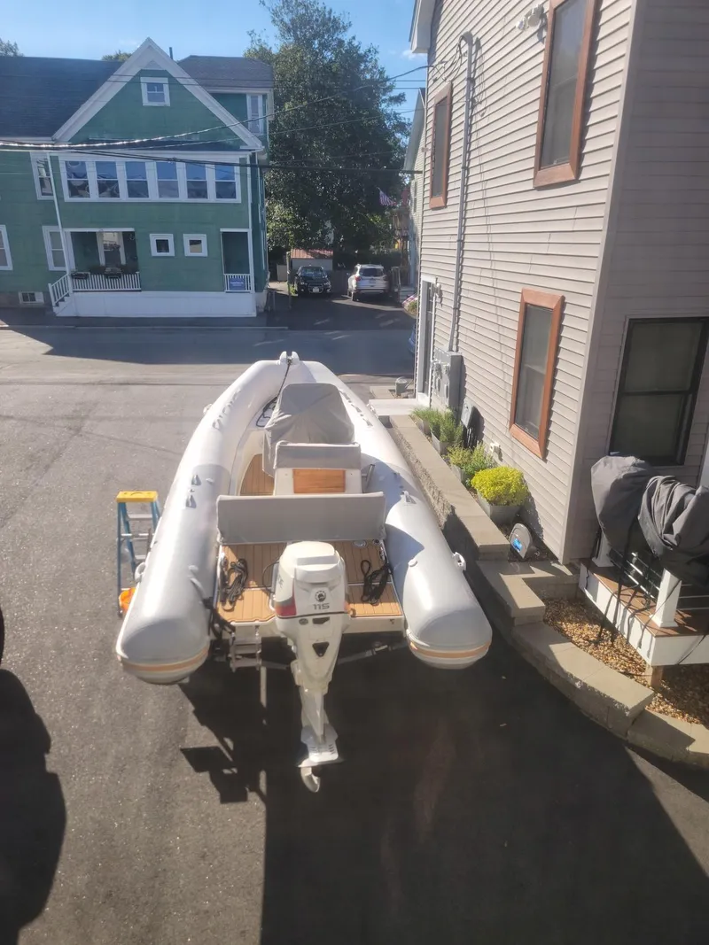 Slide: The Image of 2014 Zodiac Medline 580 inflatable boat parked in a residential driveway. - 24