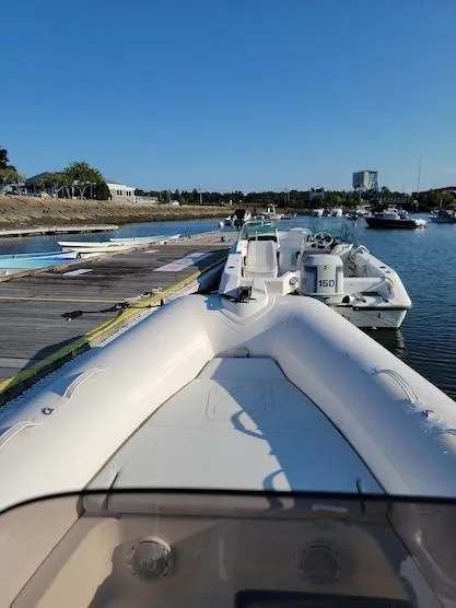 Slide: The Image of 2014 Zodiac Medline 580 boat docked at a marina on a sunny day. - 27