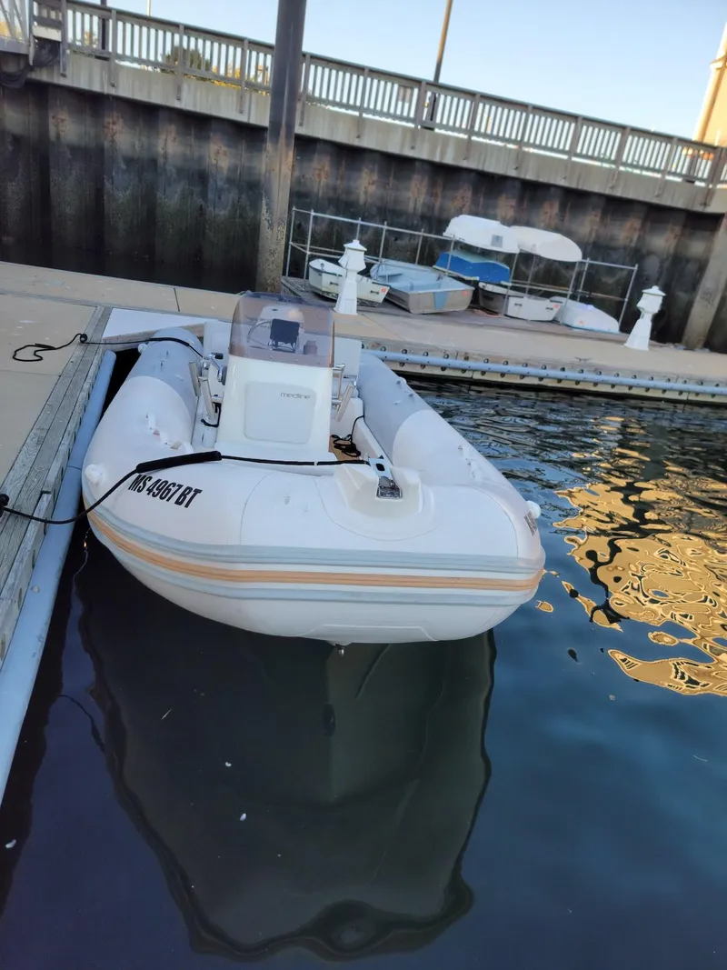 Slide: The Image of 2014 Zodiac Medline 580 inflatable boat docked at a marina. - 3