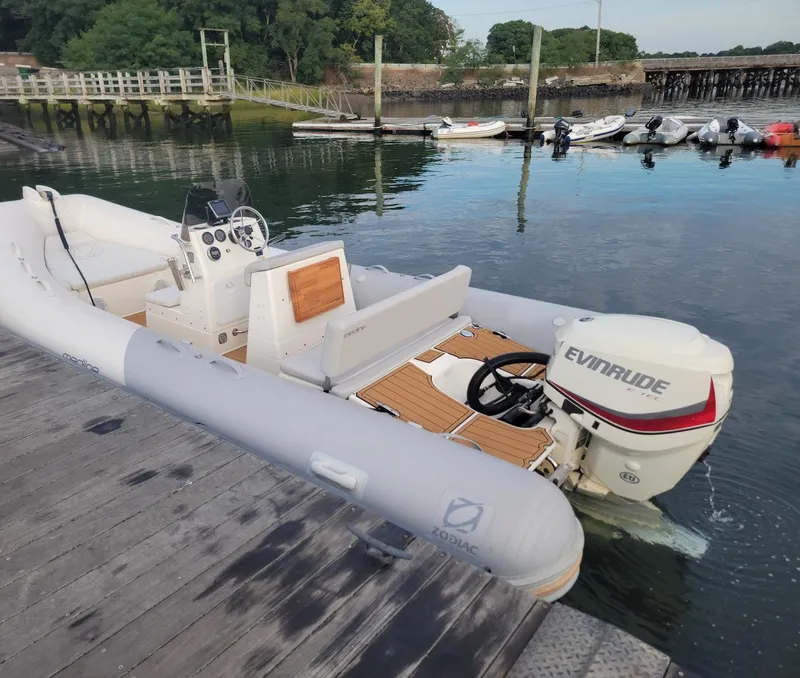 Slide: The Image of 2014 Zodiac Medline 580 inflatable boat docked with Evinrude outboard motor. - 6