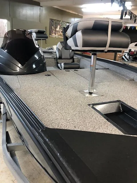 Slide: The Image of 2023 Polar Kraft 165BATX fishing boat interior with seating and storage compartments. - 2