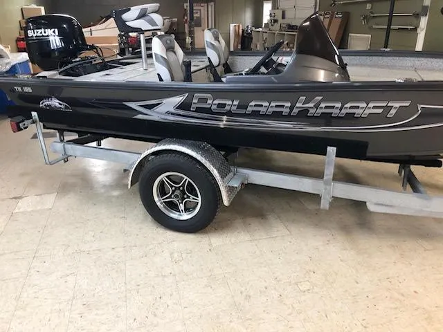 The Image of 2023 Polar Kraft 165BATX boat on trailer in indoor setting. - 0
