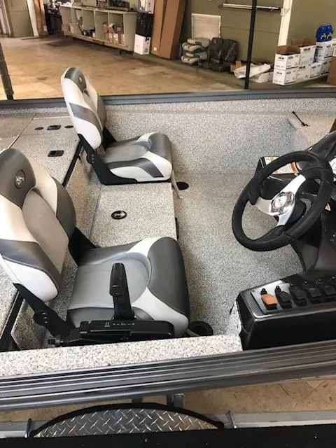 Slide: The Image of 2023 Polar Kraft 165BATX boat interior with dual seats and steering console. - 3