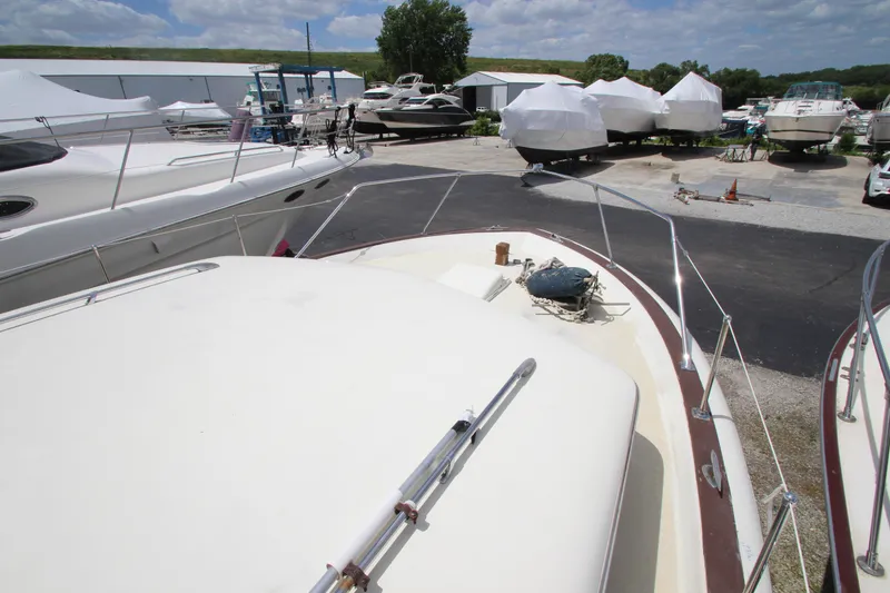 Slide: The Image of 1965 Chris-Craft Commander yacht in a marina with other boats. - 13