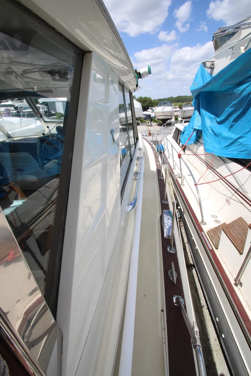 Slide: The Image of 1965 Chris-Craft Commander boat docked at a marina on a sunny day. - 15