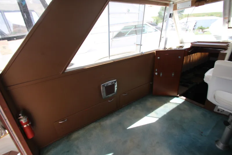 Slide: The Image of Interior of a 1965 Chris-Craft Commander boat with brown paneling and blue carpet. - 18