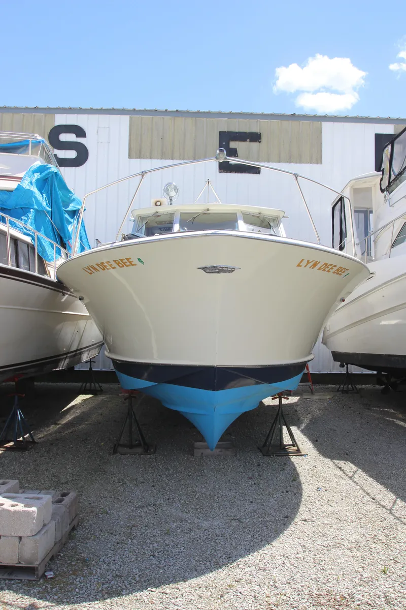 Slide: The Image of 1965 Chris-Craft Commander boat on dry dock between other boats. - 2