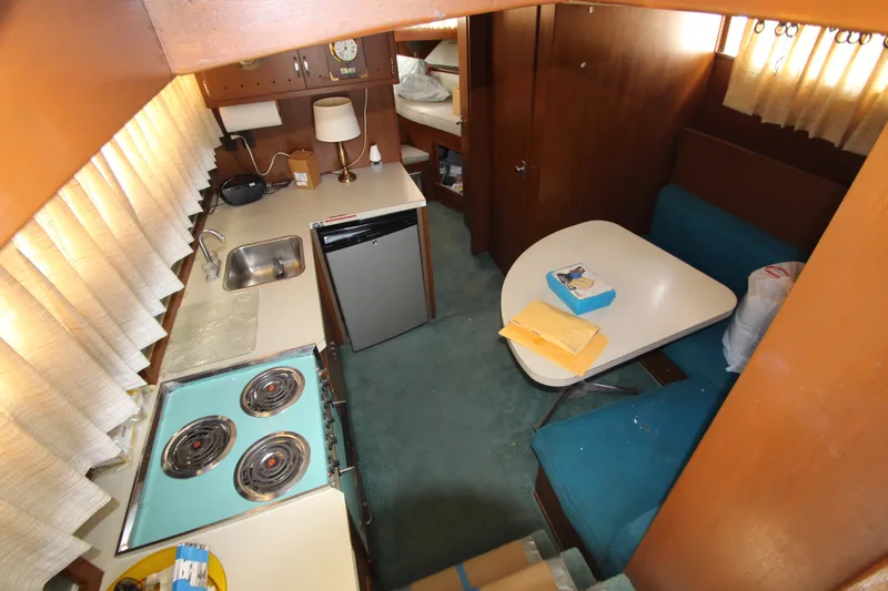 Slide: The Image of 1965 Chris-Craft Commander interior with kitchen, dining area, and teal upholstery. - 20