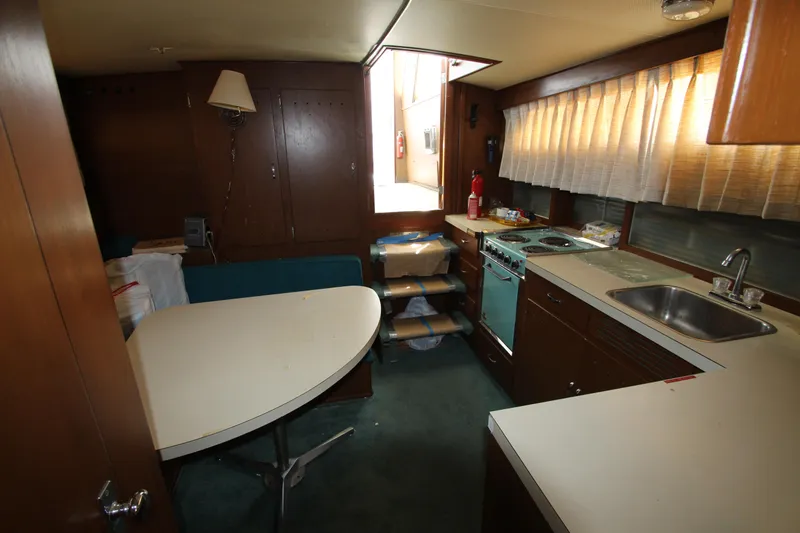 Slide: The Image of 1965 Chris-Craft Commander interior with kitchen and dining area. - 21
