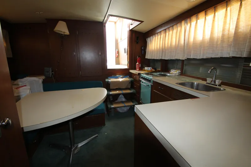 Slide: The Image of 1965 Chris-Craft Commander interior with kitchen and dining area. - 22