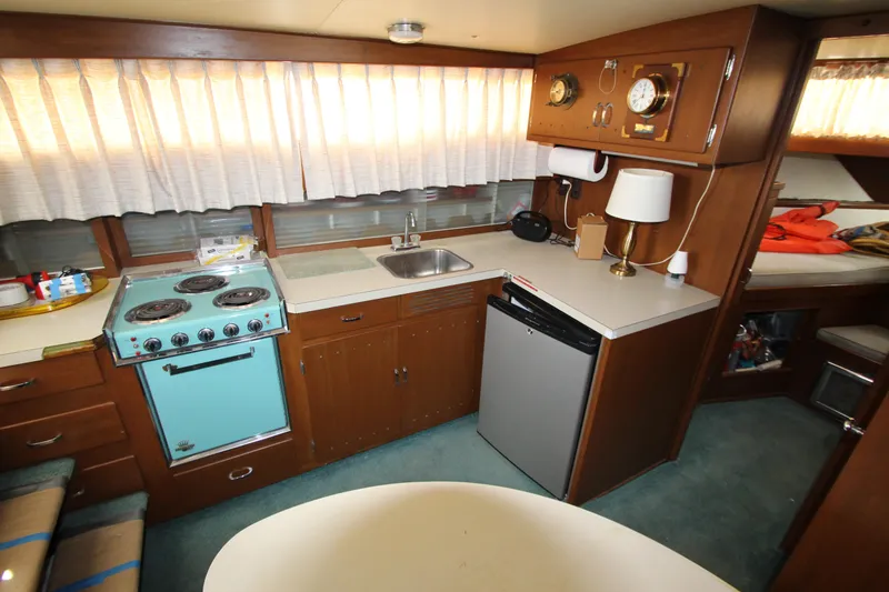 Slide: The Image of 1965 Chris-Craft Commander kitchen with vintage stove, sink, and mini-fridge. - 24