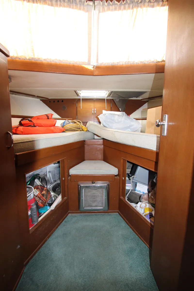 Slide: The Image of 1965 Chris-Craft Commander cabin interior with twin beds and storage compartments. - 27