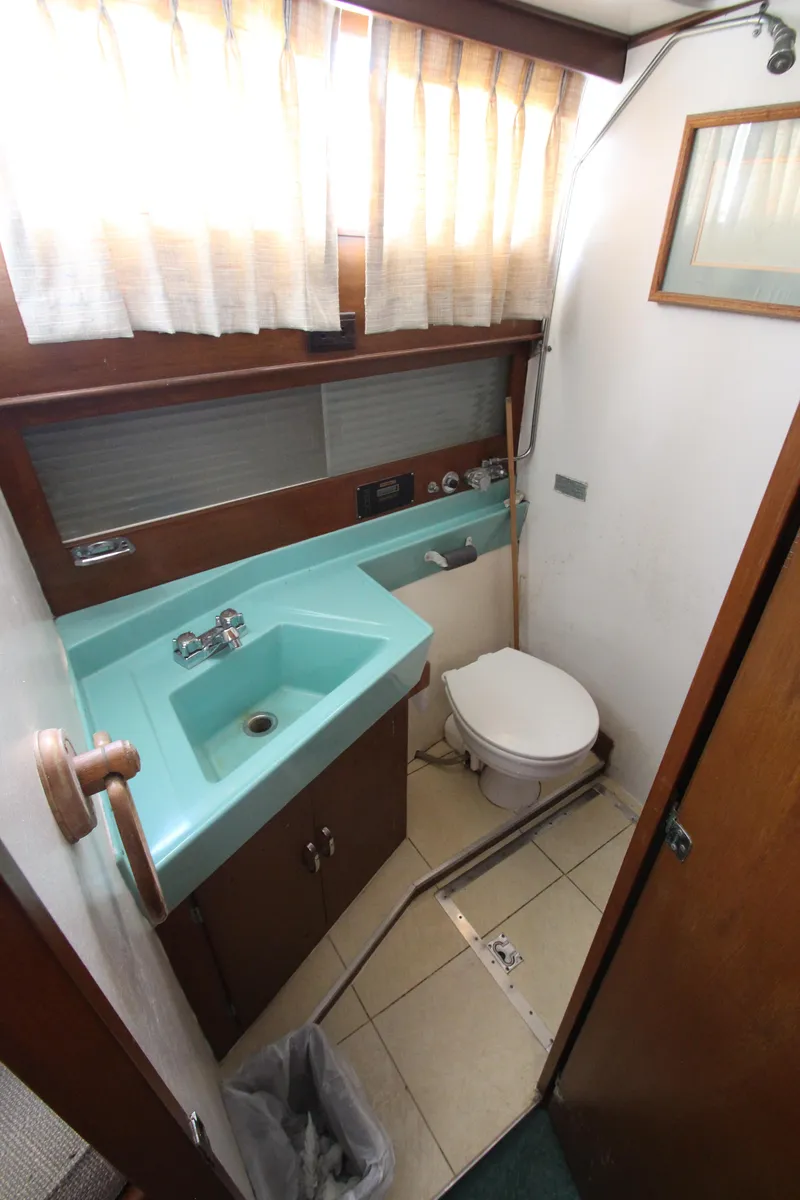Slide: The Image of 1965 Chris-Craft Commander bathroom with turquoise sink and toilet. - 29