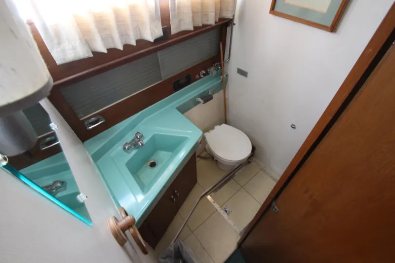 Slide: The Image of 1965 Chris-Craft Commander bathroom with turquoise sink and toilet. - 30