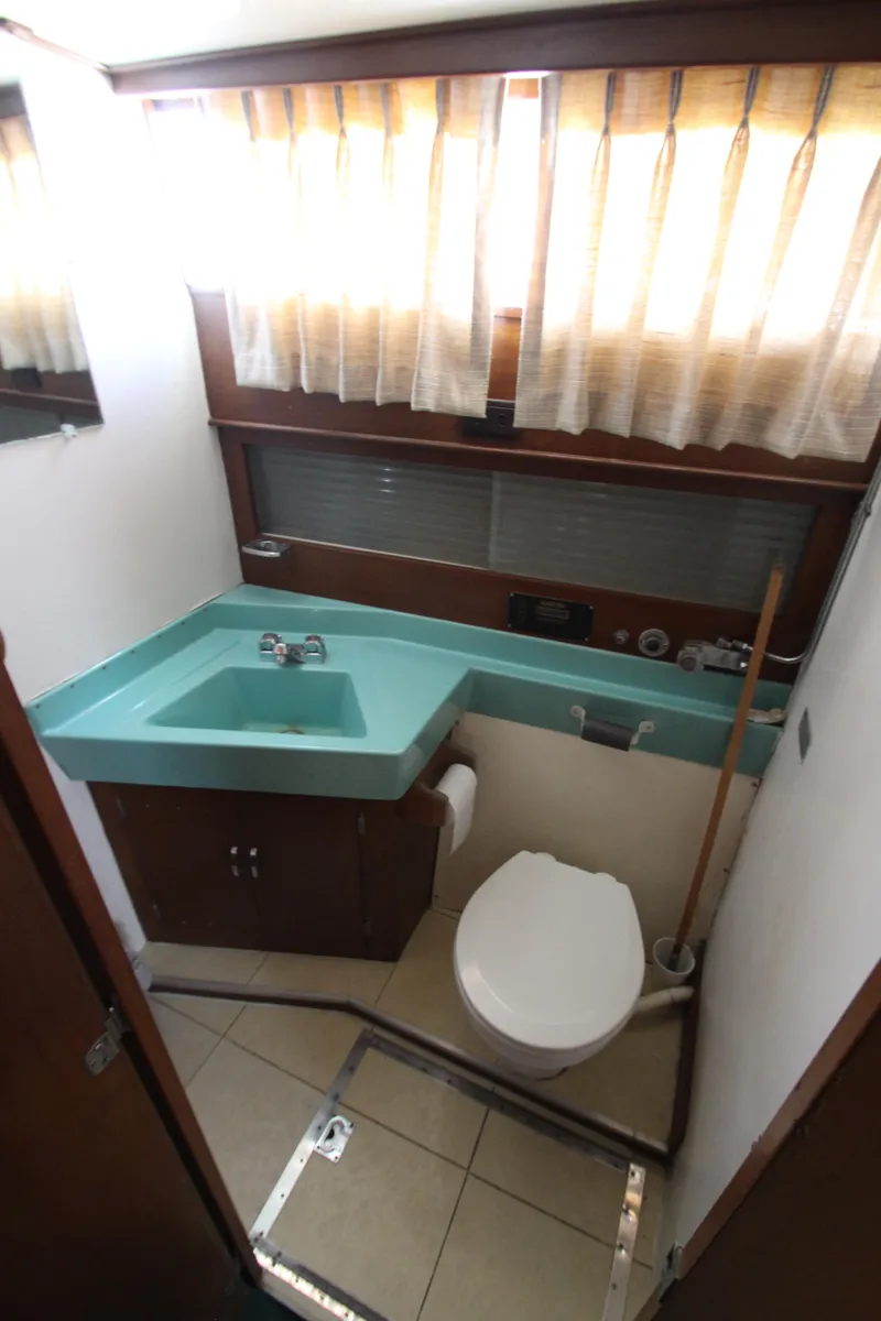 Slide: The Image of 1965 Chris-Craft Commander bathroom with turquoise sink and white toilet. - 32