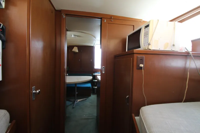 Slide: The Image of Interior of a 1965 Chris-Craft Commander boat with wood paneling and a microwave. - 35