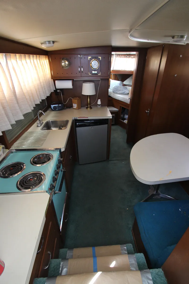Slide: The Image of 1965 Chris-Craft Commander interior with kitchen, dining area, and sleeping quarters. - 36