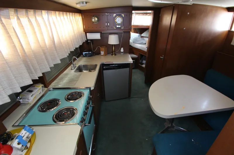 Slide: The Image of 1965 Chris-Craft Commander interior with kitchen, dining area, and sleeping quarters. - 37