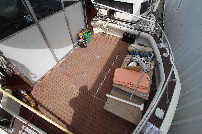 Slide: The Image of 1965 Chris-Craft Commander boat deck with wooden flooring and various equipment. - 4
