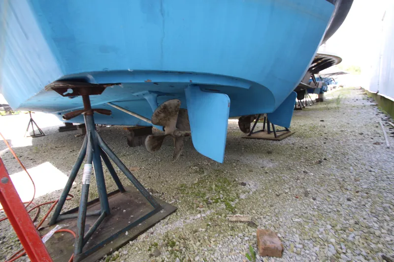 Slide: The Image of 1965 Chris-Craft Commander boat on stands, showing propeller and rudder. - 41