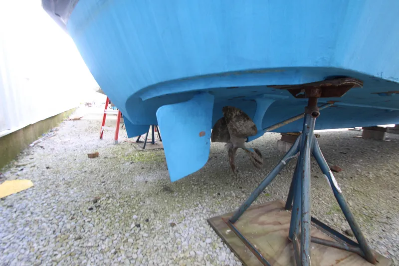 Slide: The Image of 1965 Chris-Craft Commander boat hull on stands, showing propeller and rudder. - 42