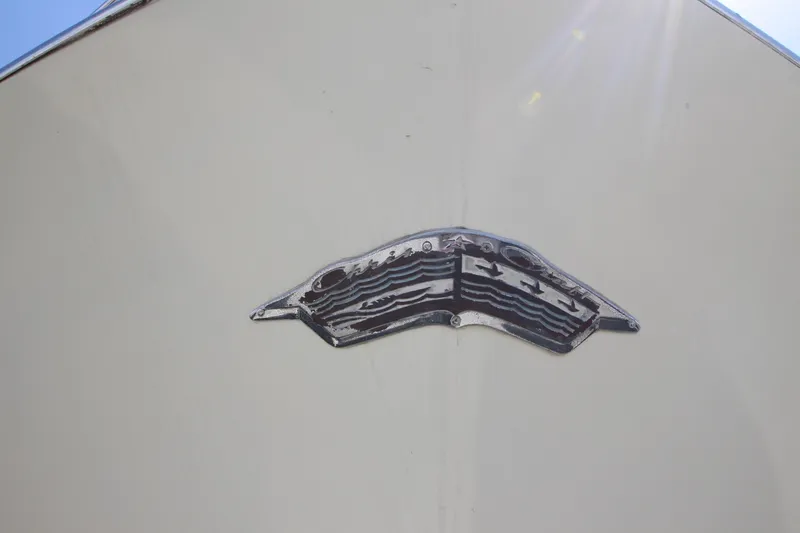 Slide: The Image of 1965 Chris-Craft Commander boat emblem on white hull. - 43