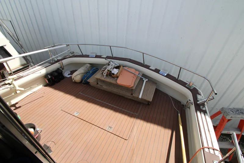 Slide: The Image of 1965 Chris-Craft Commander boat deck with wooden flooring and storage items. - 5