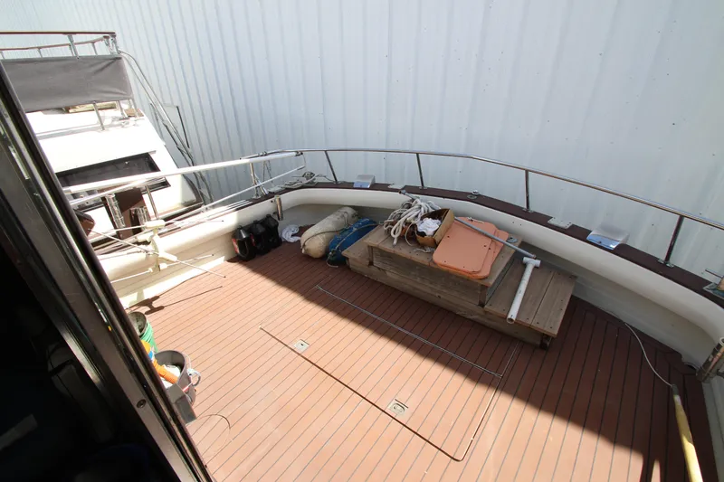 Slide: The Image of 1965 Chris-Craft Commander boat deck with wooden flooring and storage bench. - 6